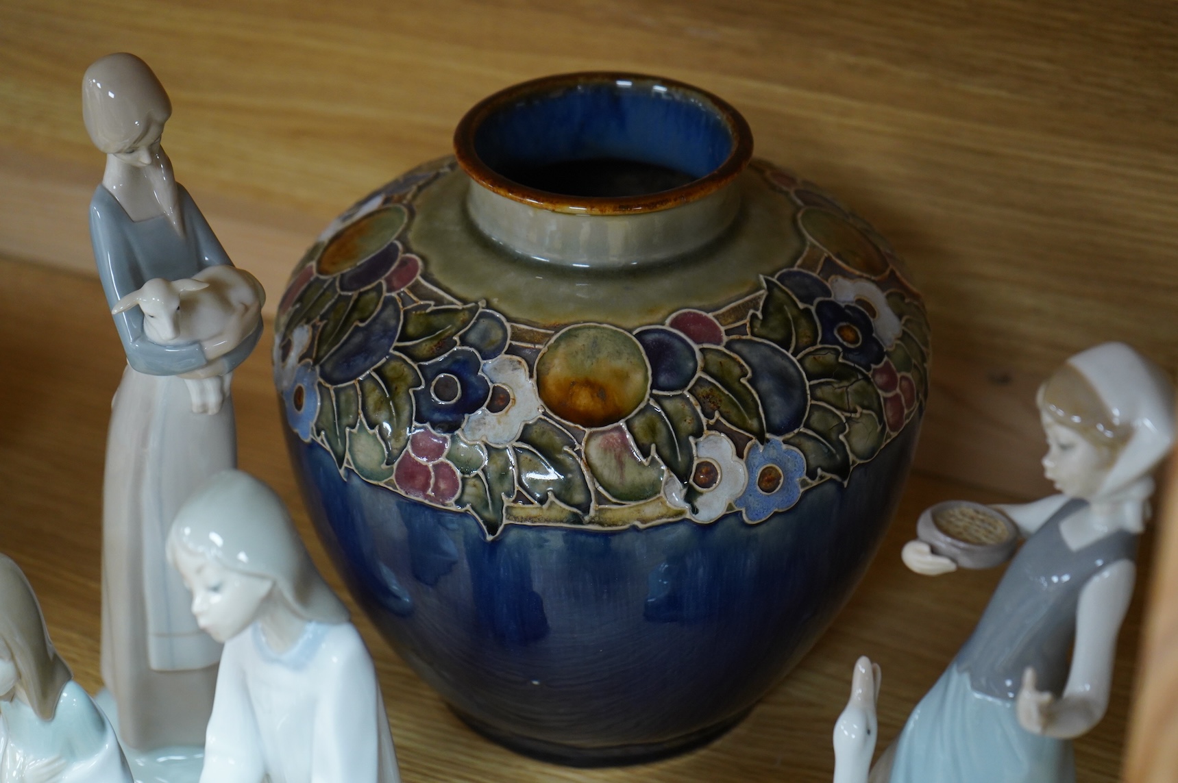 Two Doulton vases, a Casa Pupo pierrot dish and a collection of nine Lladro figures, largest 27cm high